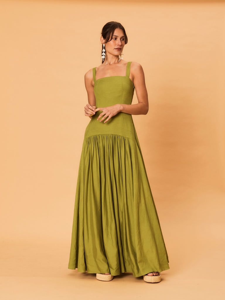 A young woman wearing La Maise Verde Clare Dress in green.