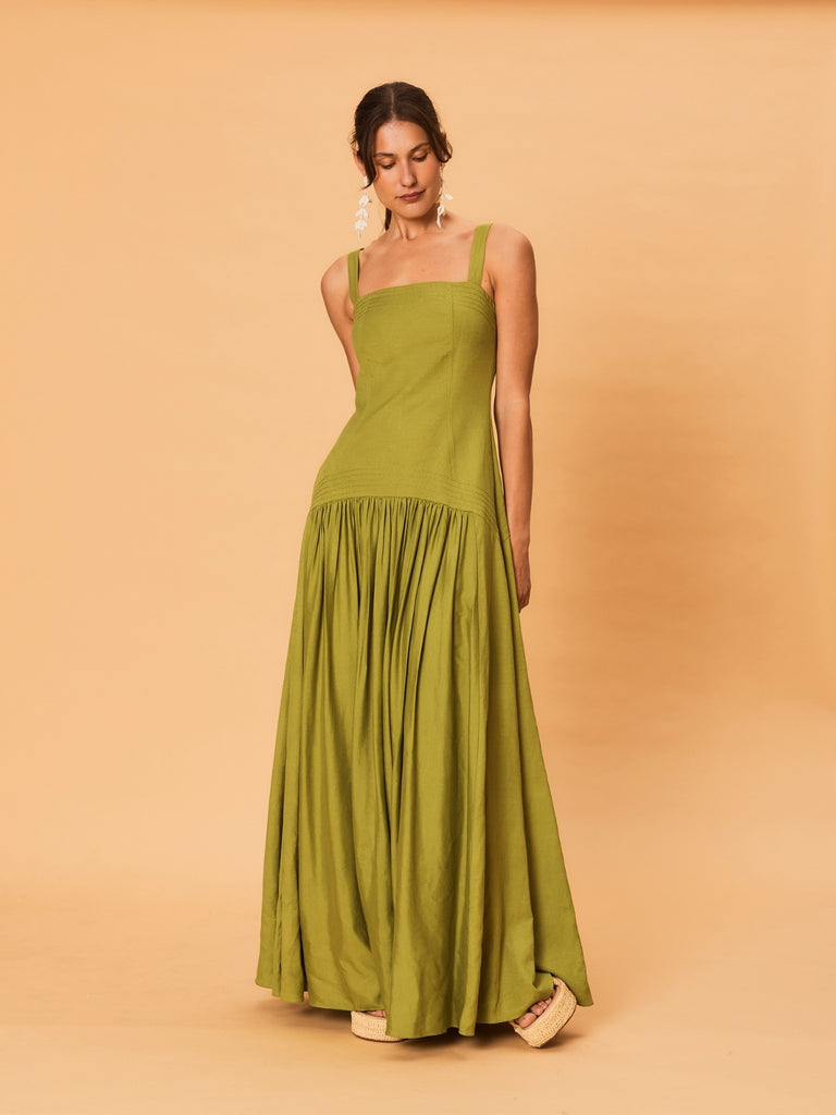 A young woman wearing La Maise Verde Clare Dress in green.