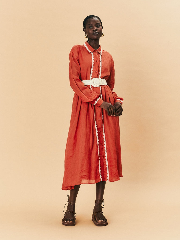 A young woman wearing La Maise Lyon Shirt Maxi Dress in rust red.