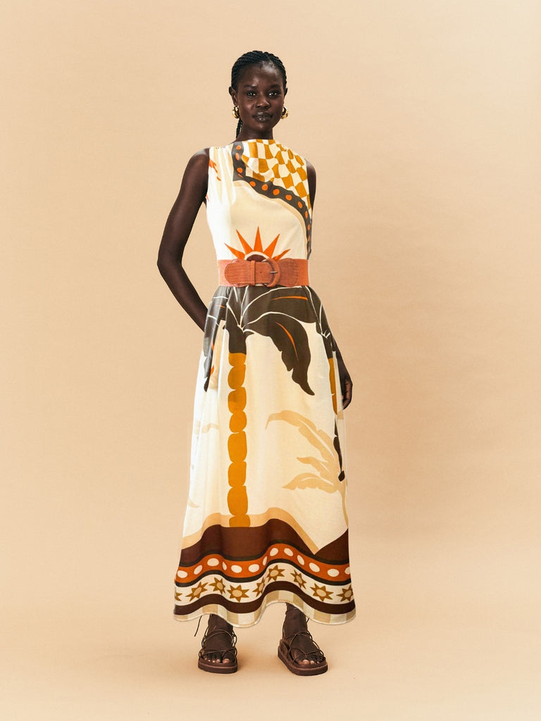 A young woman wearing La Maise blanc placement dress.